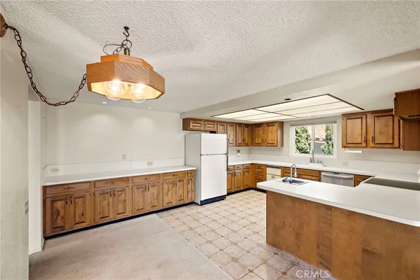 a kitchen with a sink and a stove top oven