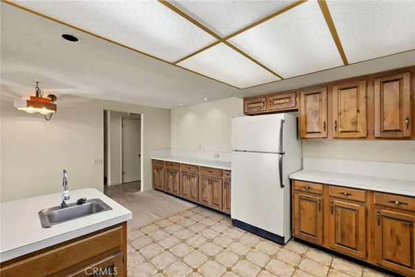 a kitchen with cabinets and refrigerator