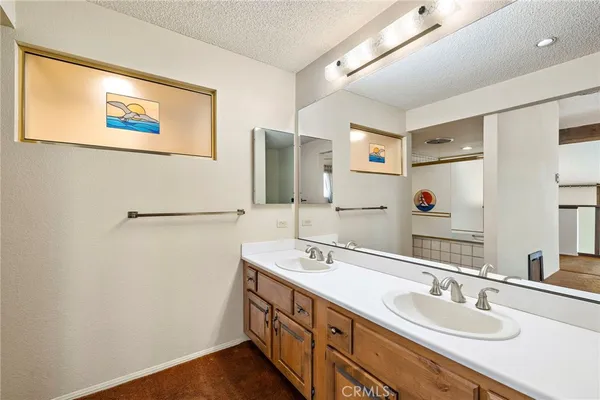 a bathroom with a double vanity sink and a mirror
