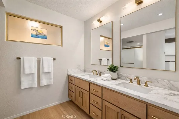 a bathroom with a double vanity sink and a mirror