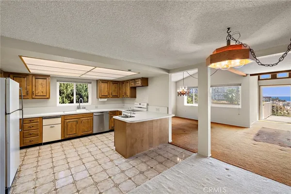 a kitchen with stainless steel appliances granite countertop a sink and a stove