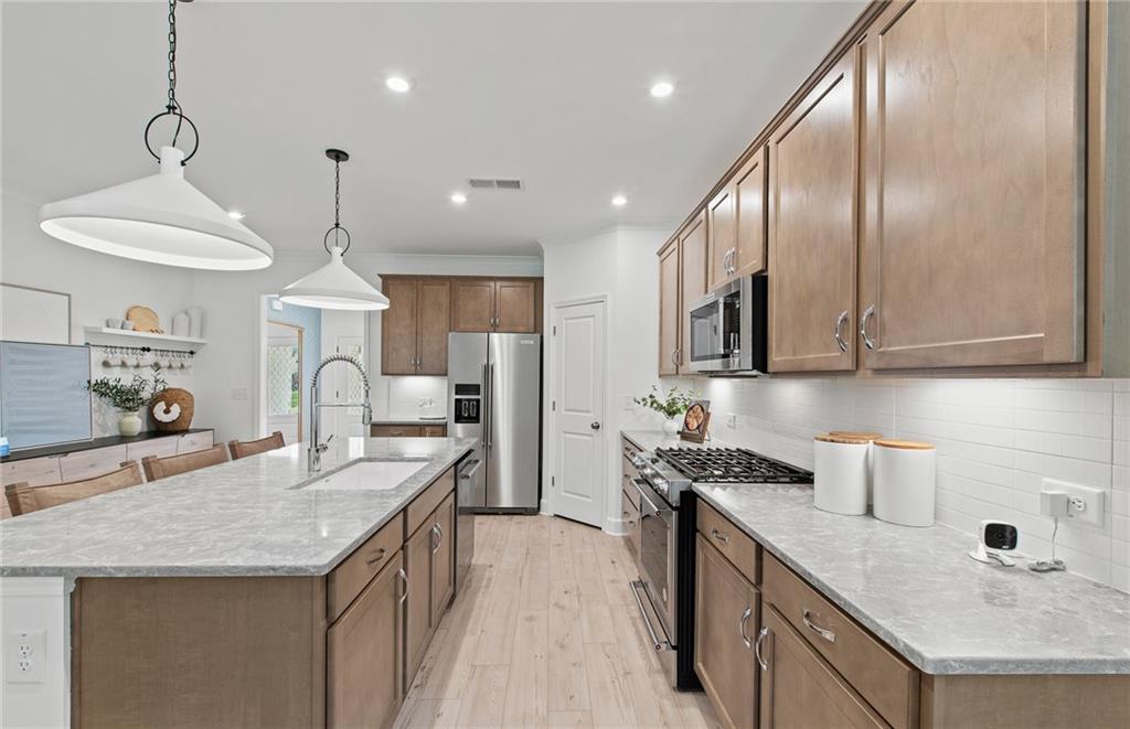 810 Tupelo Way Villa Rica, GA 30180 - Photo 13 of 41 a kitchen with granite countertop kitchen island stainless steel appliances a sink a stove and a center island