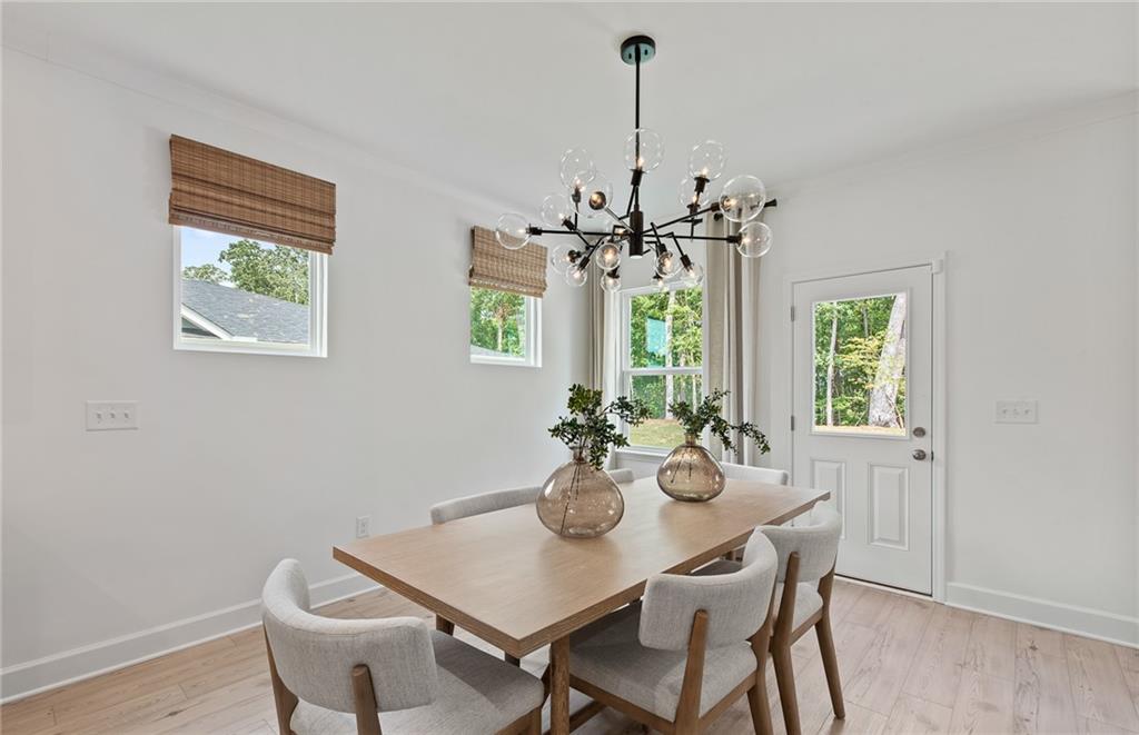 810 Tupelo Way Villa Rica, GA 30180 - Photo 17 of 41 a view of a dining room with furniture a chandelier and wooden floor
