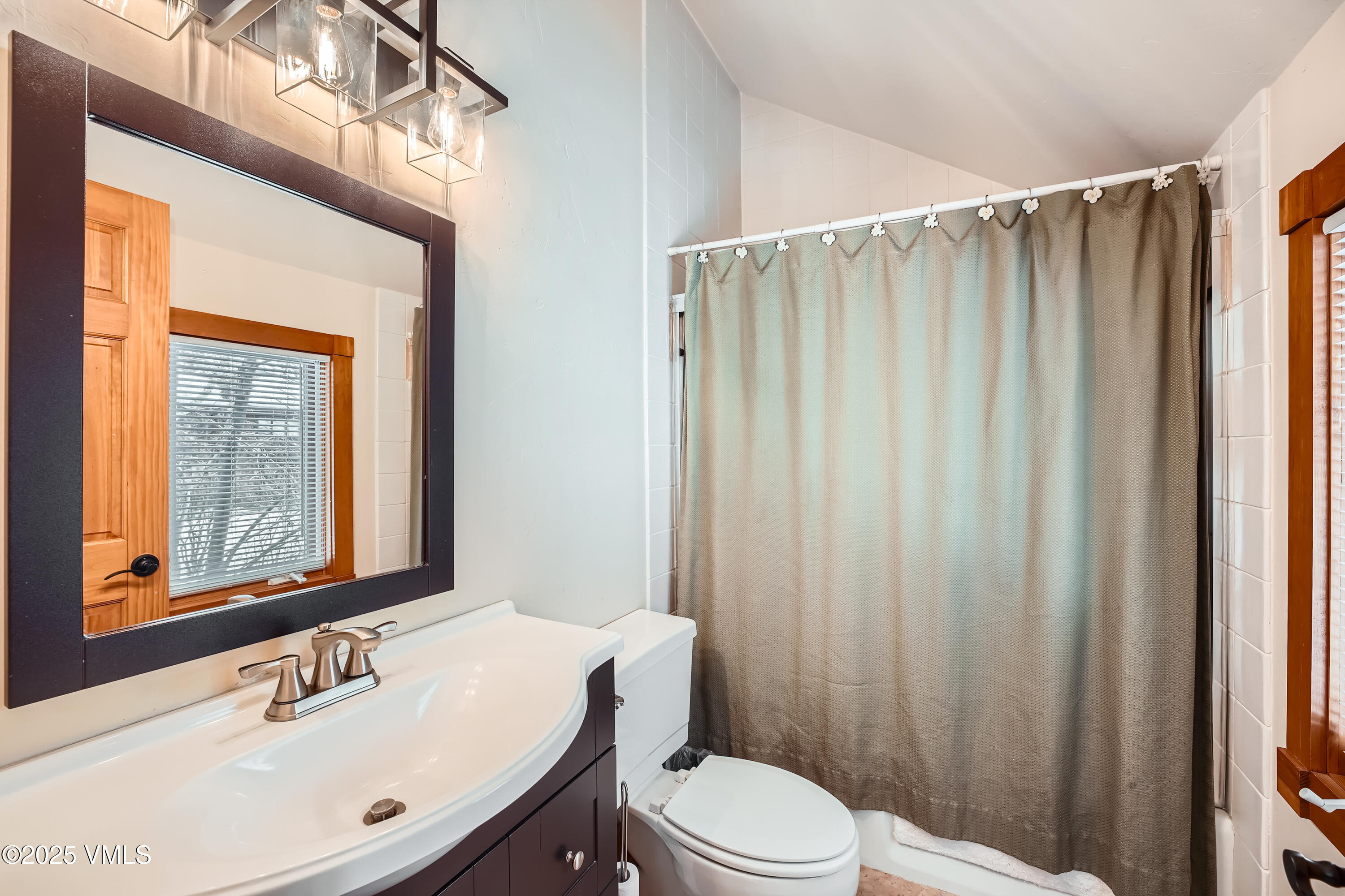 2875 Manns Ranch Road, Unit J2 Vail, CO 81657 - Photo 17 of 25 a bathroom with a sink a mirror and a toilet