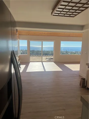 a utility room with wooden floor washer and dryer