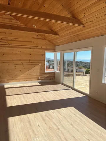 a view of a livingroom with wooden floor and a window