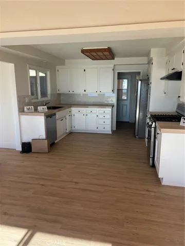 a large kitchen with stainless steel appliances kitchen island granite countertop a large counter top and cabinets