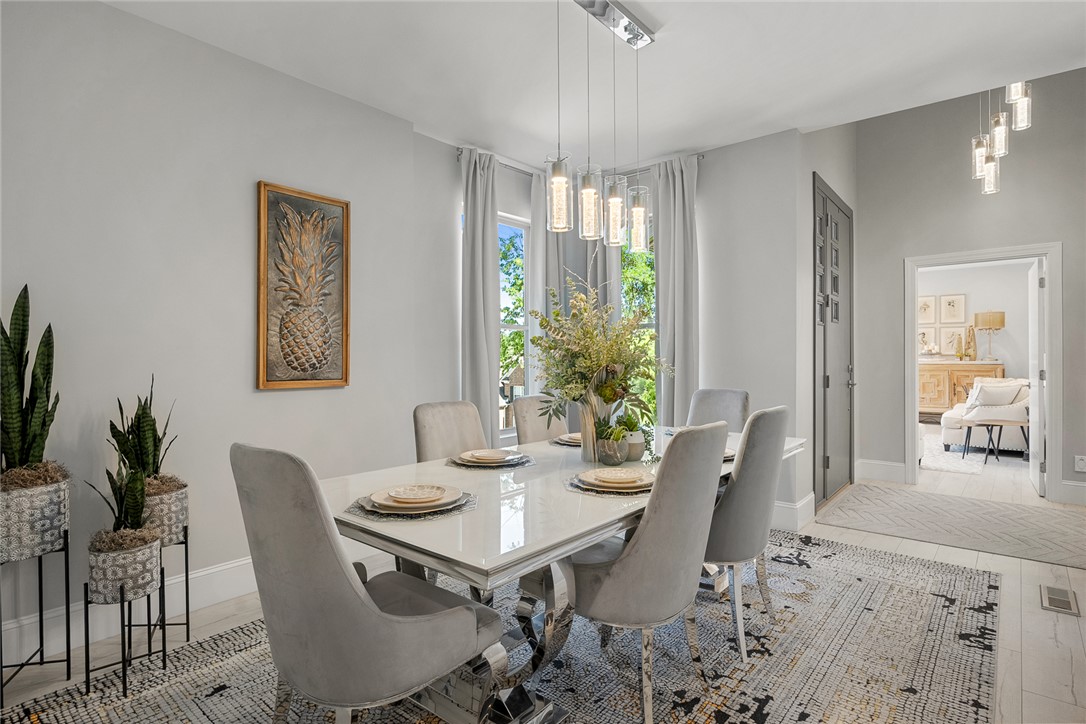 140 Turnberry Road Anderson, SC 29621 - Photo 14 of 44 This elegant dining area features a glossy white table and plush seating, illuminated by modern pendant lighting.