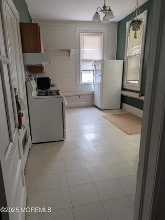 a bathroom with a toilet and a shower curtain