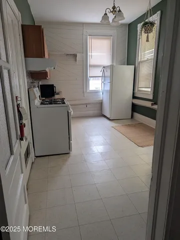 a bathroom with a toilet and a shower curtain