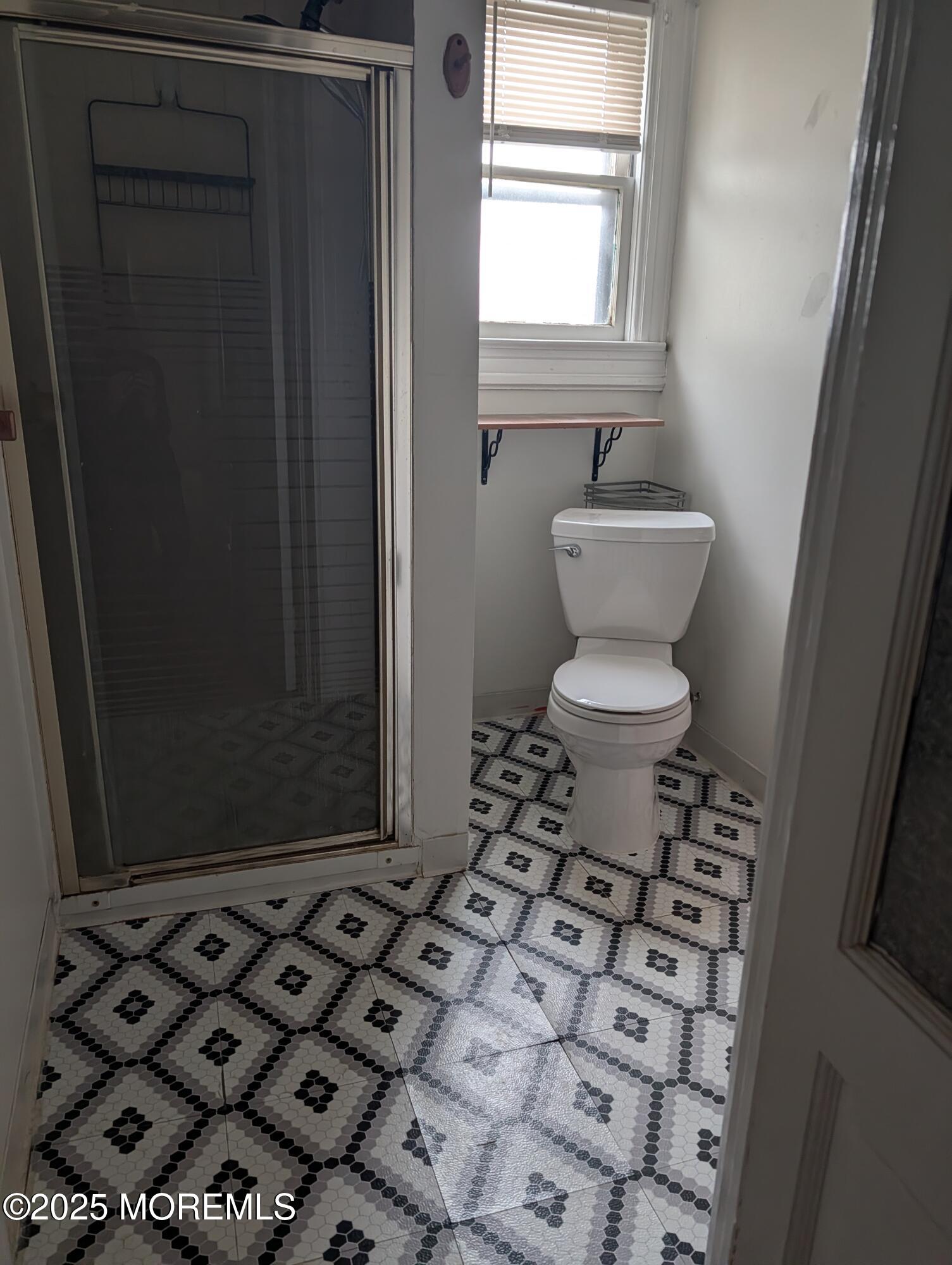 5 Wharf Avenue, Unit A Red Bank, NJ 07701 - Photo 6 of 7 a bathroom with a toilet and a shower curtain