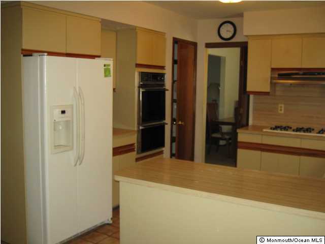 18 Spicy Pond Road Howell, NJ 07731 - Photo 3 of 11 a kitchen with stainless steel appliances a refrigerator and a stove