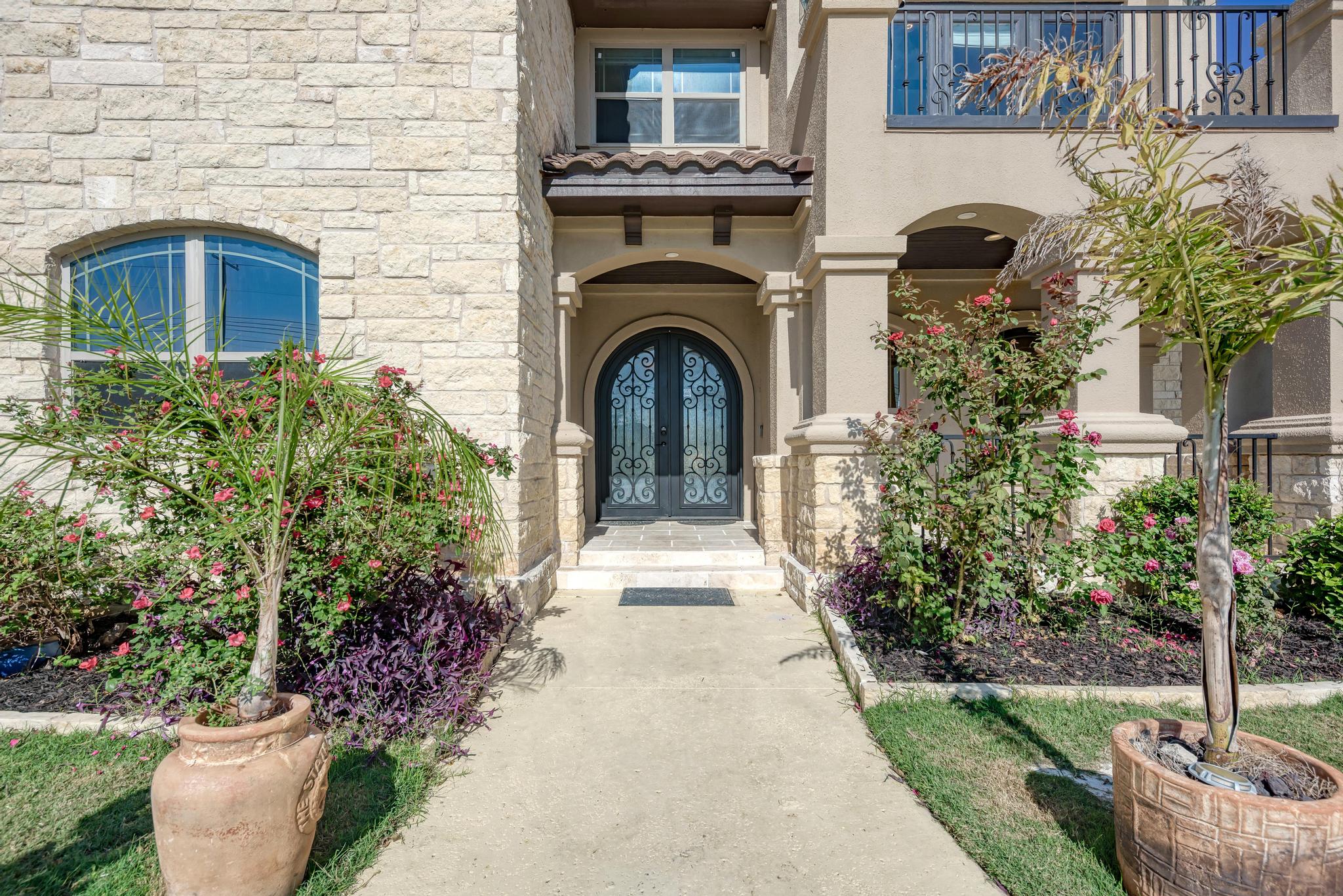 104 Spring Valley Street Hutto, TX 78634 - Photo 7 of 40 Property entrance featuring stone siding and stucco siding