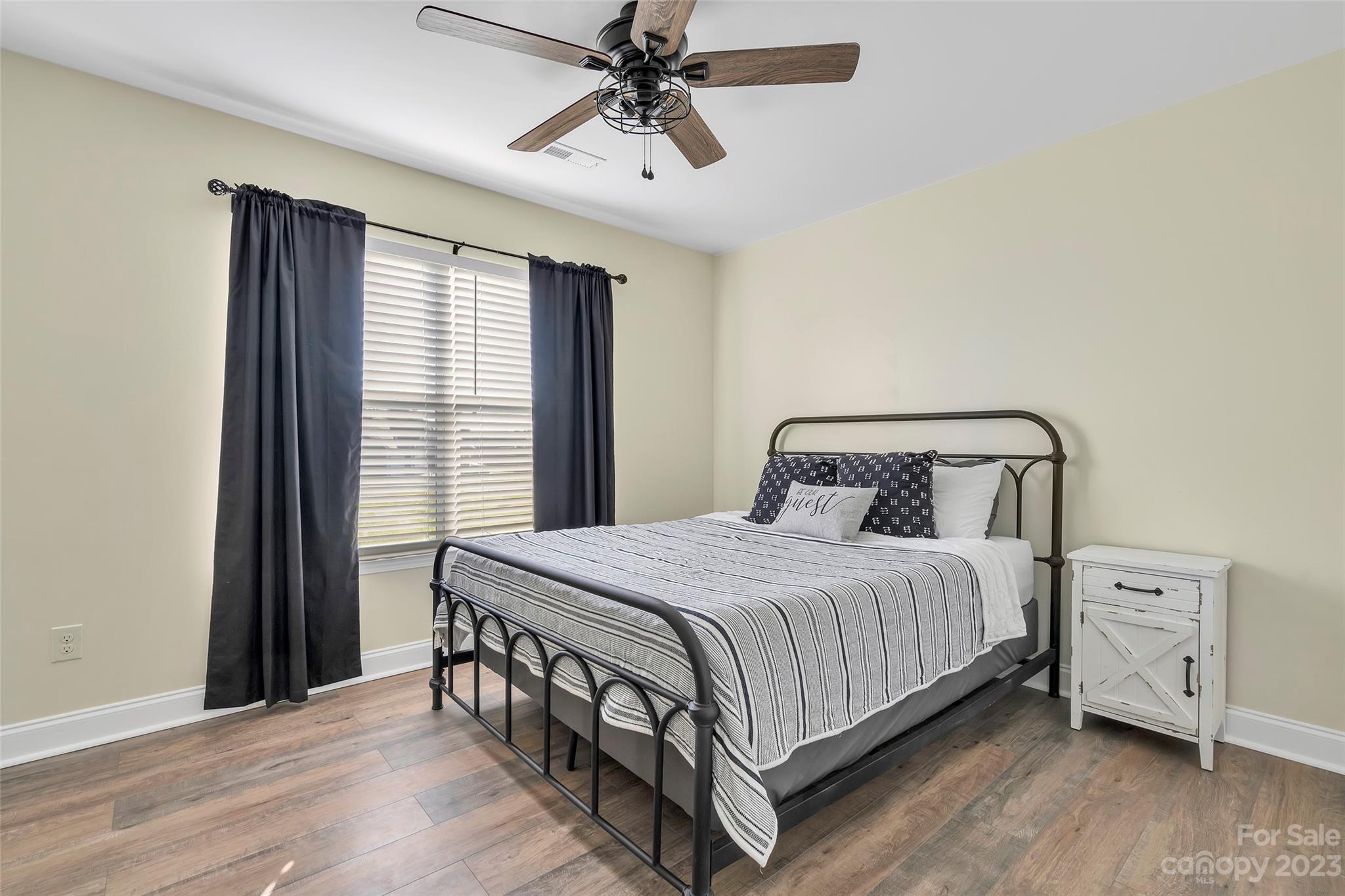 871 West Keepsake Lane Inman, SC 29349 - Photo 19 of 26 a bedroom with a bed and a chandelier