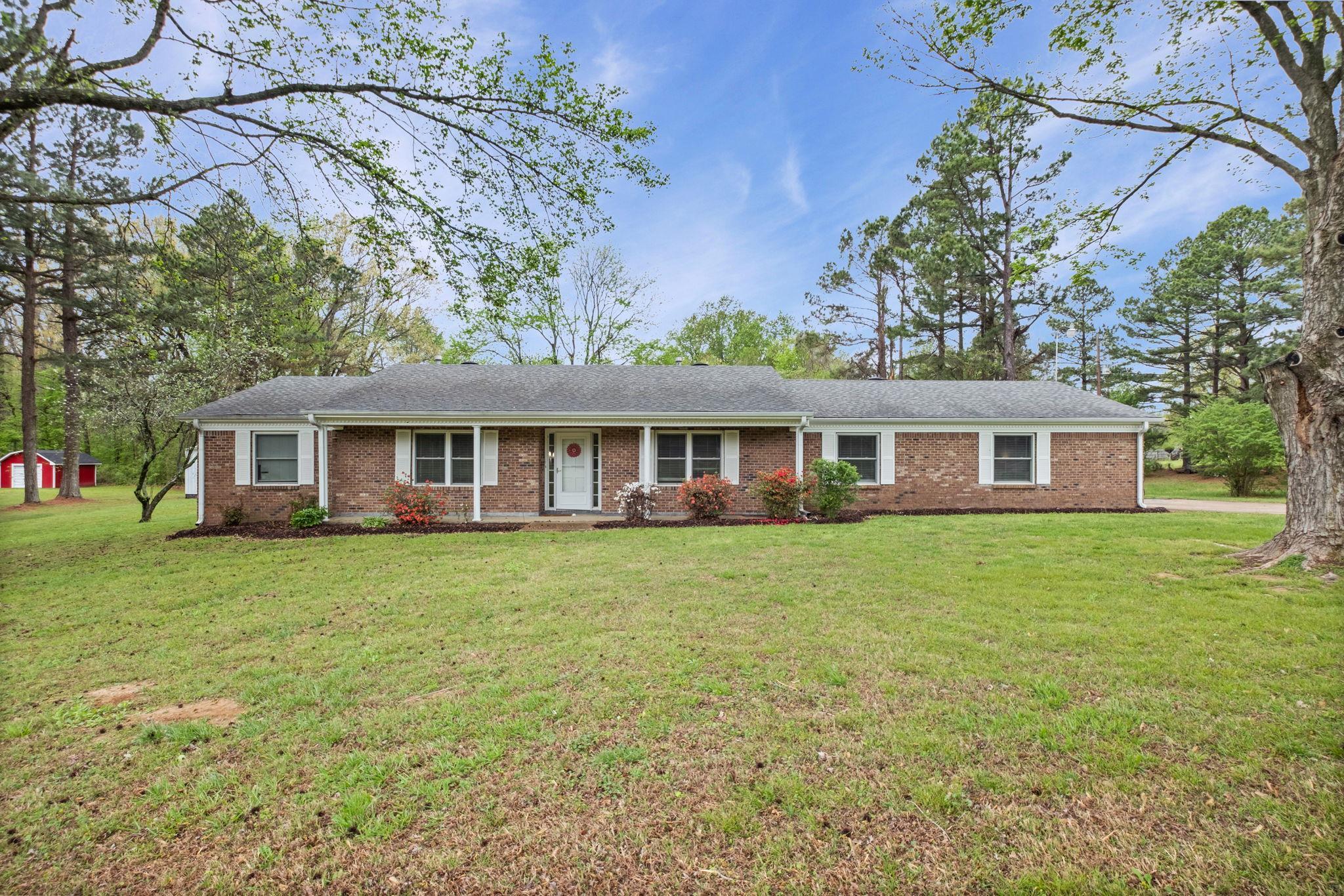 58 Hayes Road Munford, TN 38058 - Photo 2 of 40 Single story home with covered porch, a front yard, and brick siding