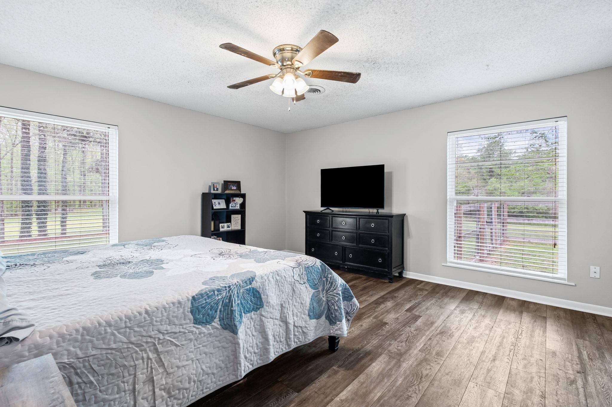 58 Hayes Road Munford, TN 38058 - Photo 24 of 40 Bedroom with dark wood-style flooring, a textured ceiling, and a ceiling fan