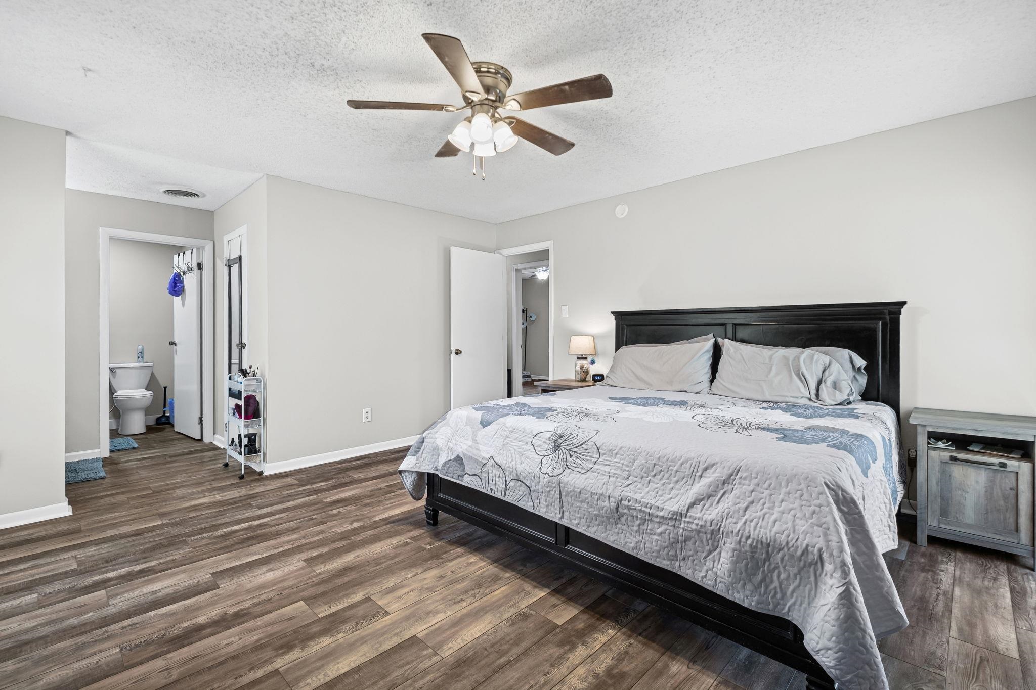 58 Hayes Road Munford, TN 38058 - Photo 25 of 40 Bedroom featuring dark wood-style flooring, a textured ceiling, and a ceiling fan