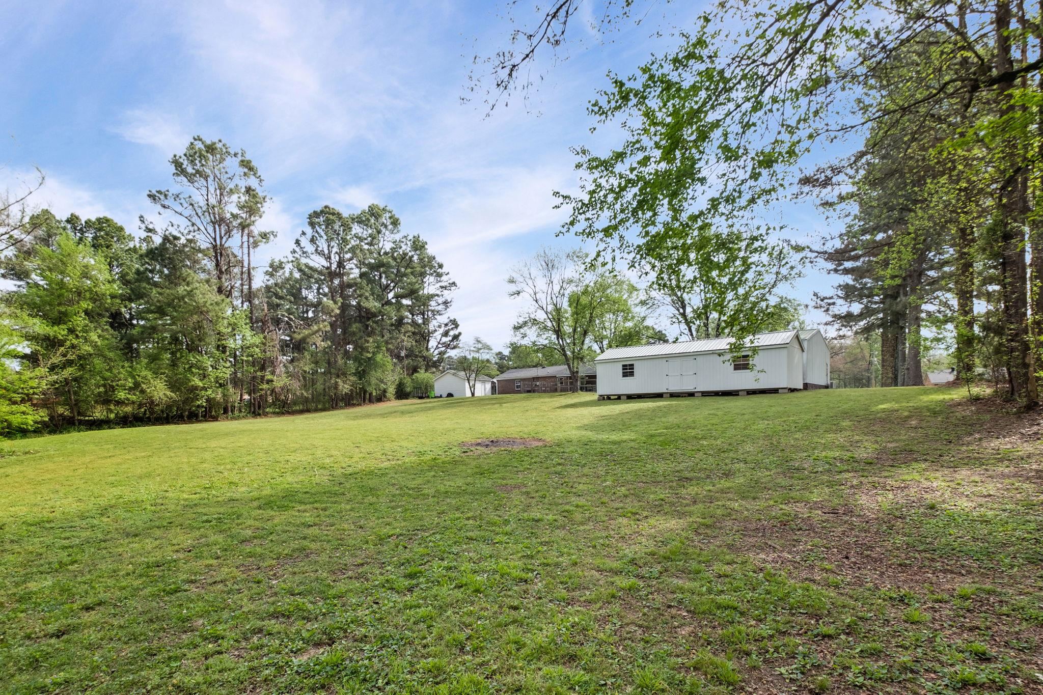 58 Hayes Road Munford, TN 38058 - Photo 36 of 40 View of green lawn with an outbuilding
