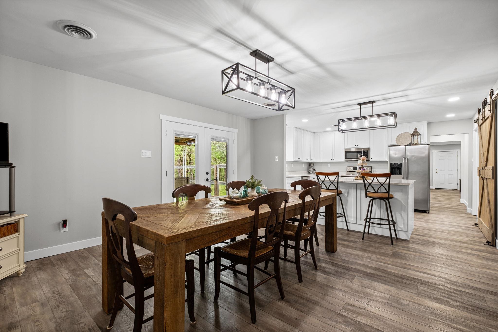 58 Hayes Road Munford, TN 38058 - Photo 9 of 40 Dining area with dark wood-style floors, french doors, recessed lighting, and a barn door