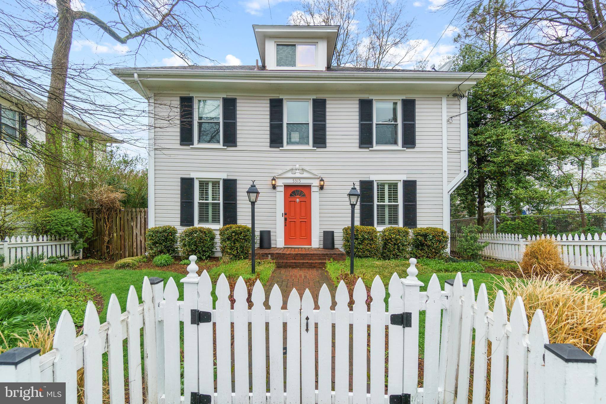 a front view of brick house with a yard