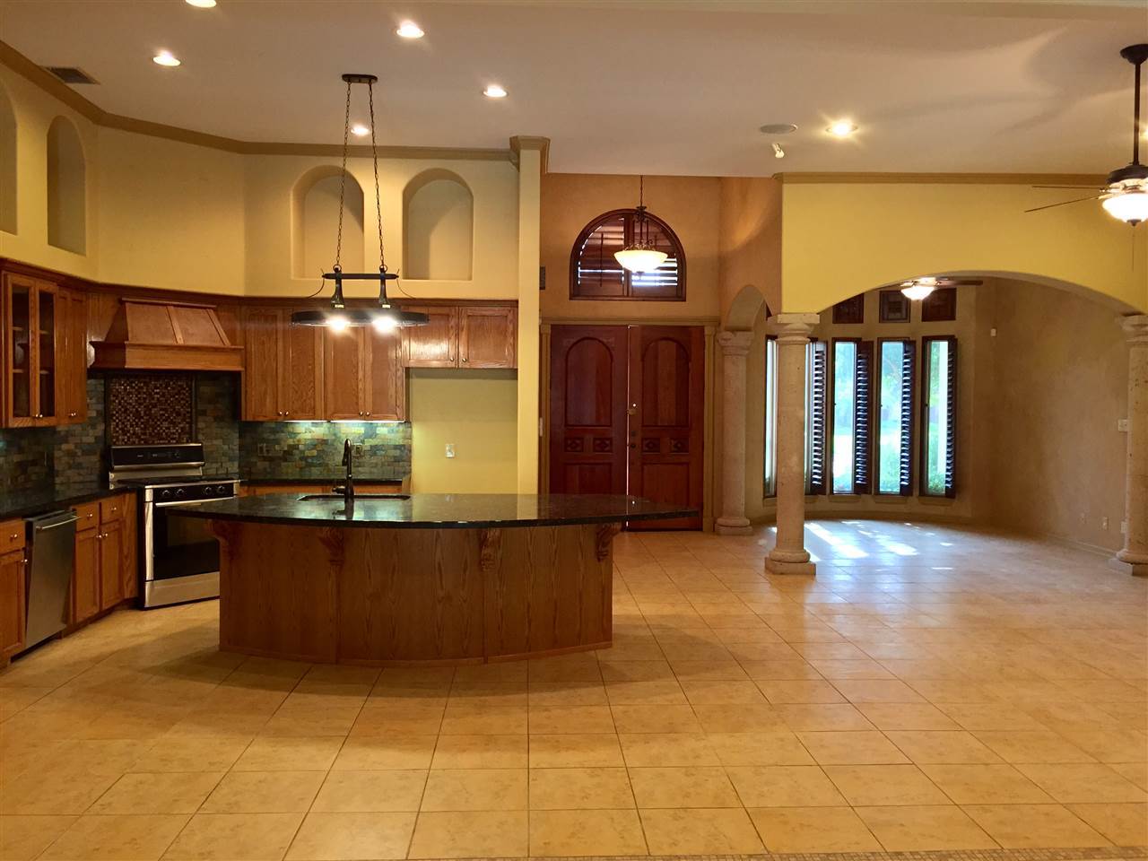 10809 Marfa Road Laredo, TX 78045 - Photo 3 of 9 a kitchen with stainless steel appliances kitchen island granite countertop a stove and cabinets