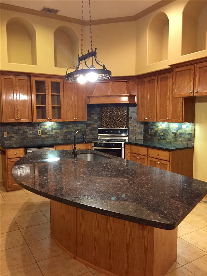 10809 Marfa Road Laredo, TX 78045 - Photo 4 of 9 a kitchen with kitchen island a counter top space appliances and cabinets