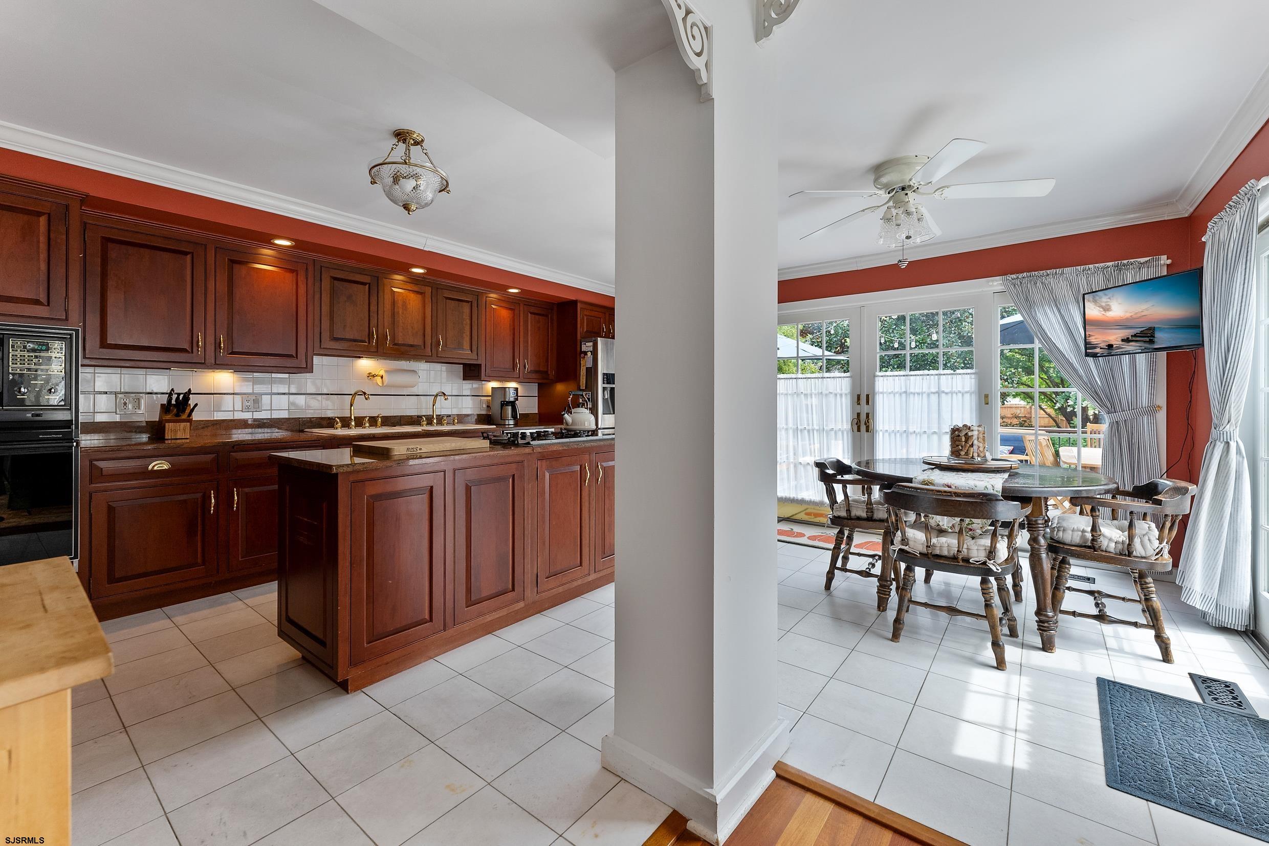 2024 Shore Road Linwood, NJ 08221 - Photo 22 of 51 a kitchen with stainless steel appliances granite countertop a stove top oven island a table and chairs in it