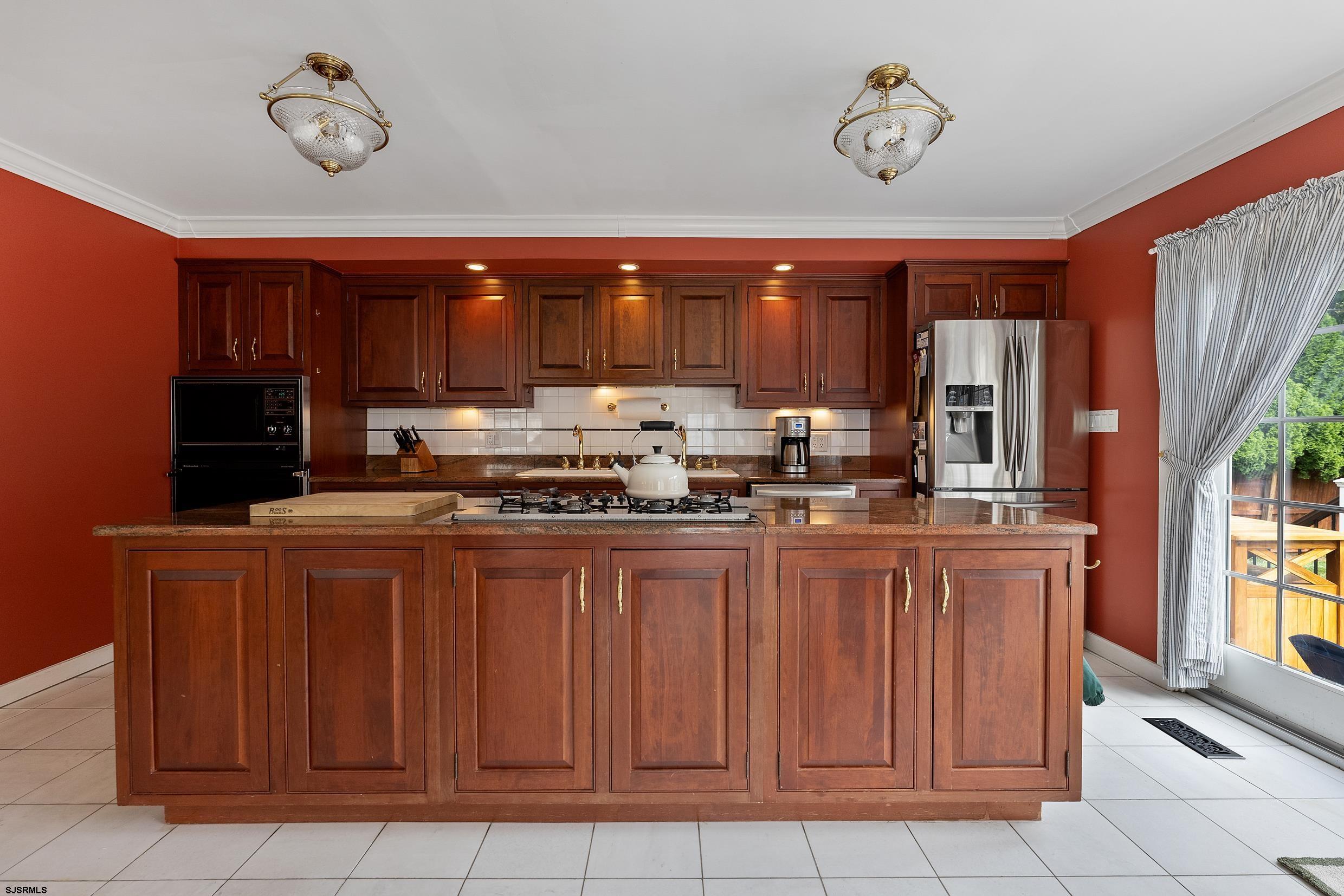 2024 Shore Road Linwood, NJ 08221 - Photo 23 of 51 a kitchen with kitchen island granite countertop a sink cabinets and window