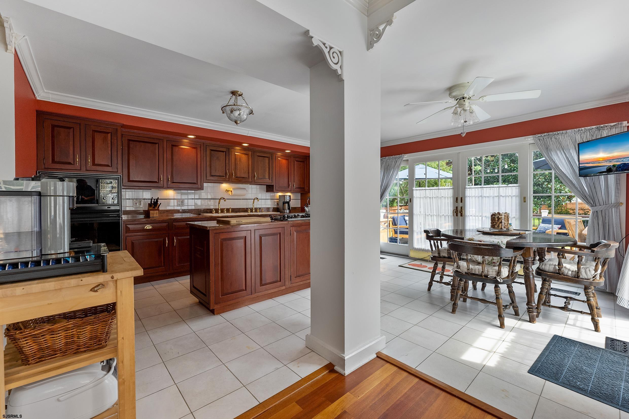 2024 Shore Road Linwood, NJ 08221 - Photo 24 of 51 a kitchen with stainless steel appliances granite countertop a stove top oven a dining table and chairs with wooden floor