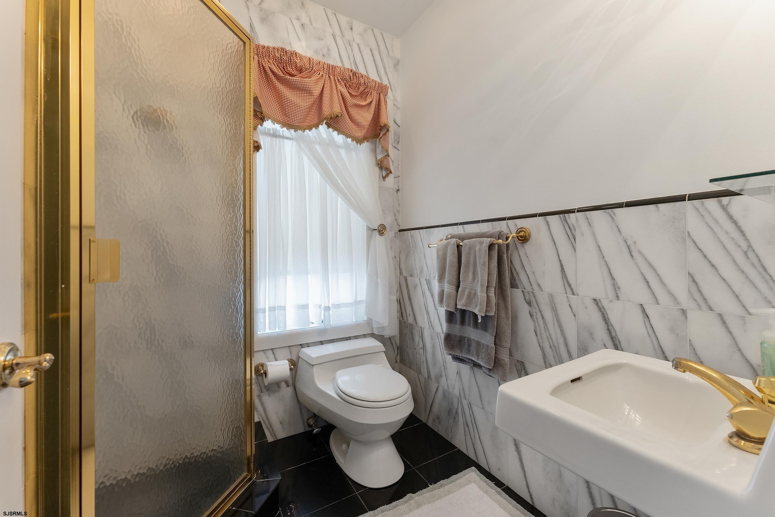 2024 Shore Road Linwood, NJ 08221 - Photo 35 of 51 a bathroom with a sink toilet and shower