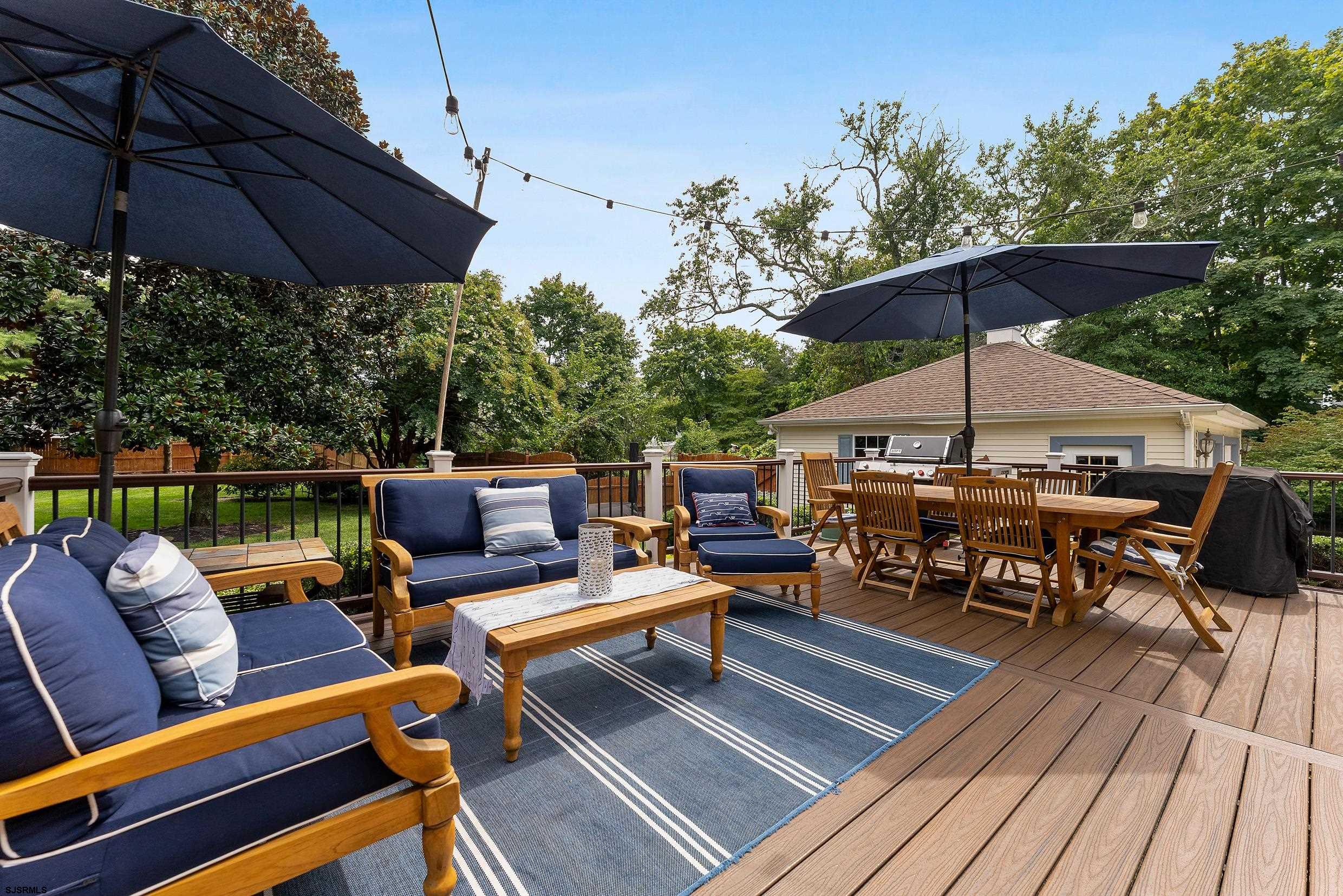 2024 Shore Road Linwood, NJ 08221 - Photo 38 of 51 an outdoor sitting area with furniture and umbrella