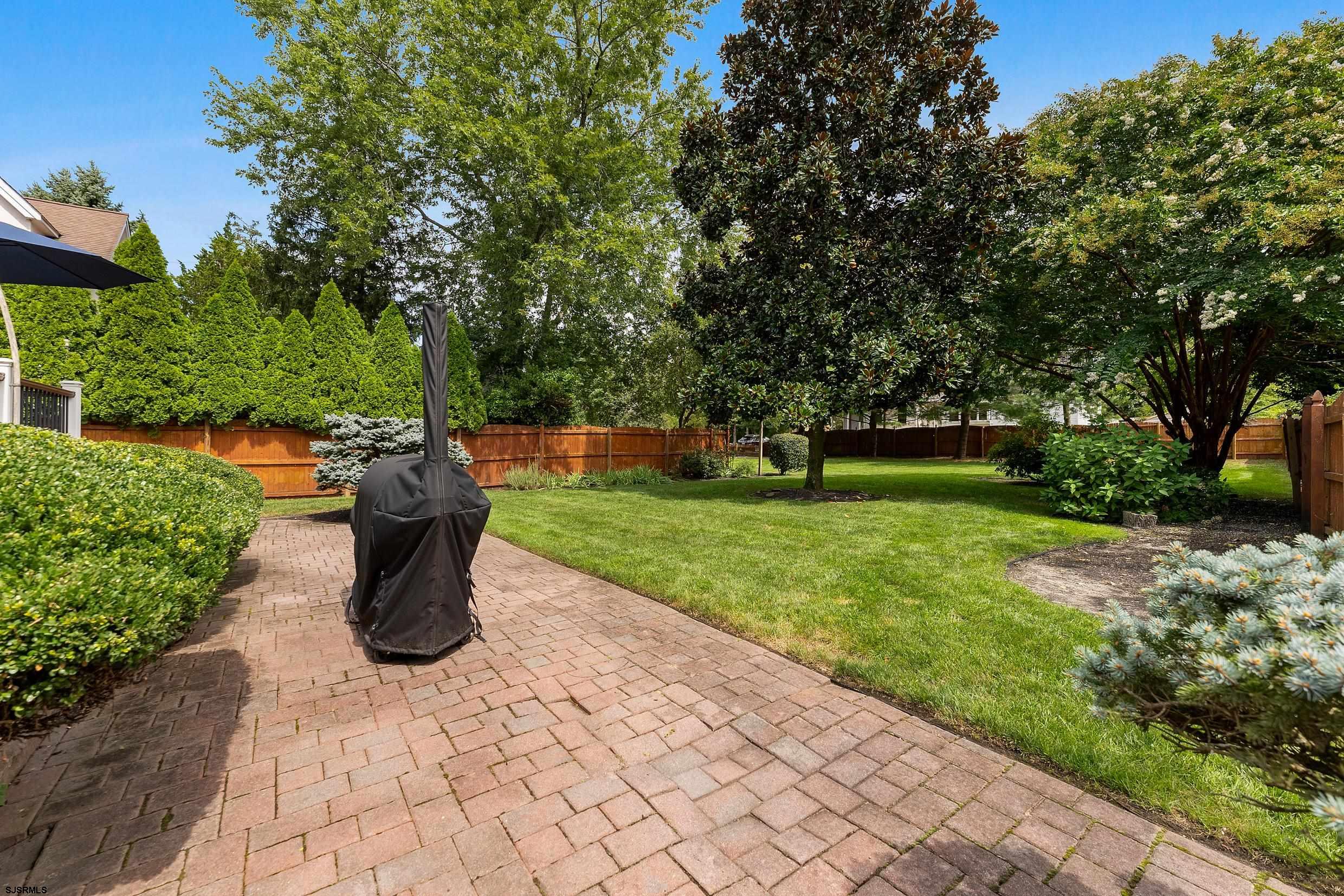 2024 Shore Road Linwood, NJ 08221 - Photo 42 of 51 a view of a garden with plants and large trees
