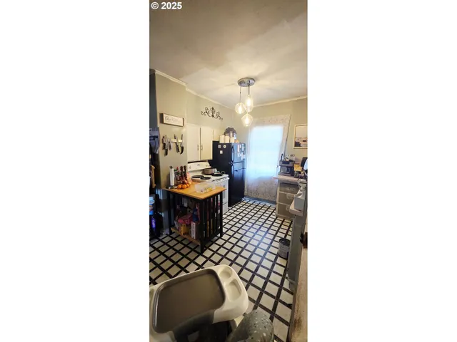 a living room with lots of furniture and clutter