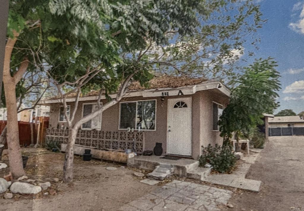 a small house with a tree in front of it