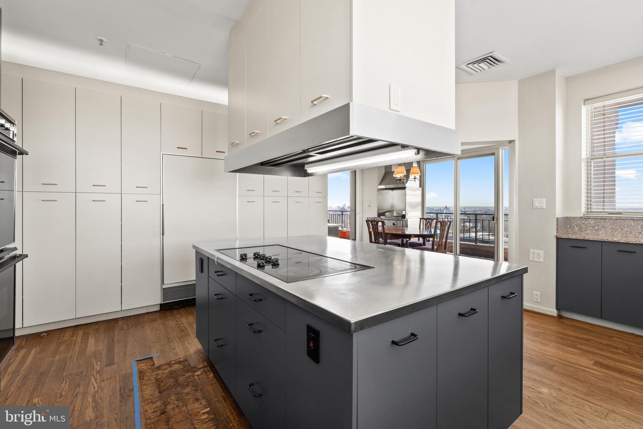 3801 Canterbury Road, Unit 1104 Baltimore, MD 21218 - Photo 21 of 74 a kitchen with a stove and a wooden floor
