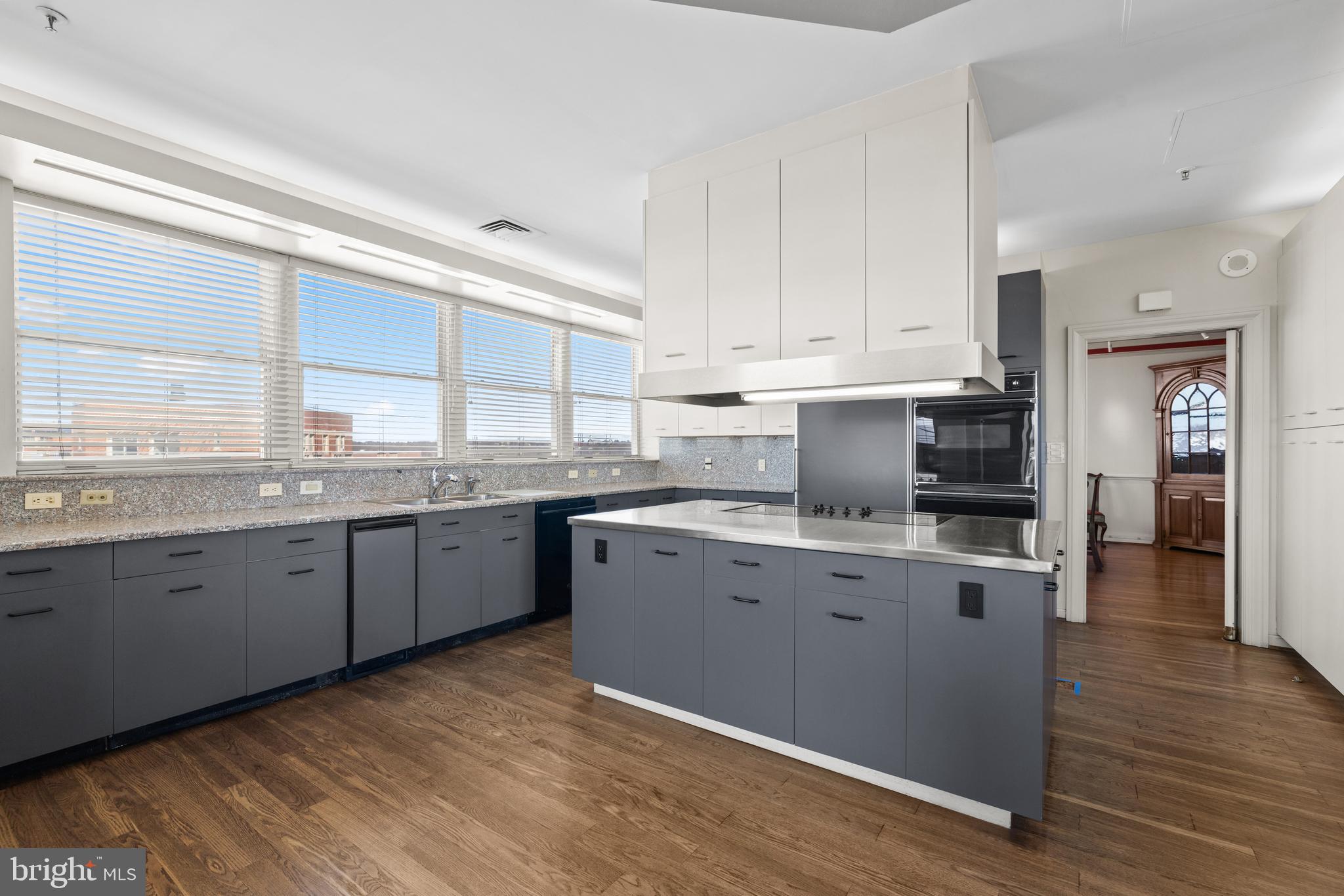 3801 Canterbury Road, Unit 1104 Baltimore, MD 21218 - Photo 23 of 74 a kitchen with granite countertop a sink cabinets stainless steel appliances and a window