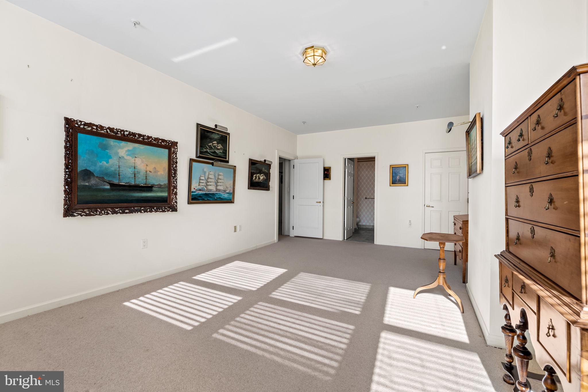 3801 Canterbury Road, Unit 1104 Baltimore, MD 21218 - Photo 42 of 74 a bedroom with furniture and flat screen tv