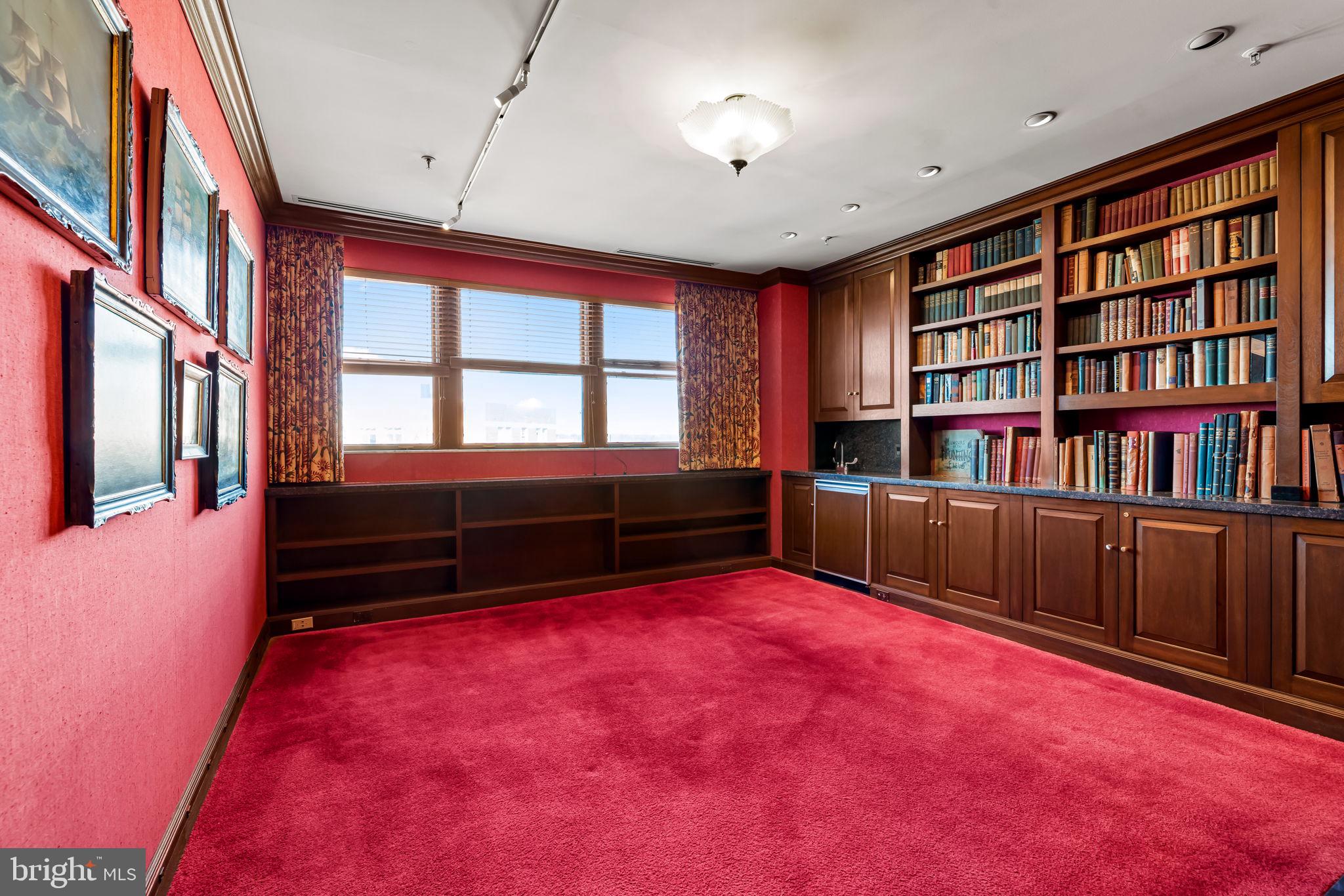 3801 Canterbury Road, Unit 1104 Baltimore, MD 21218 - Photo 47 of 74 a living room with furniture and a book shelf