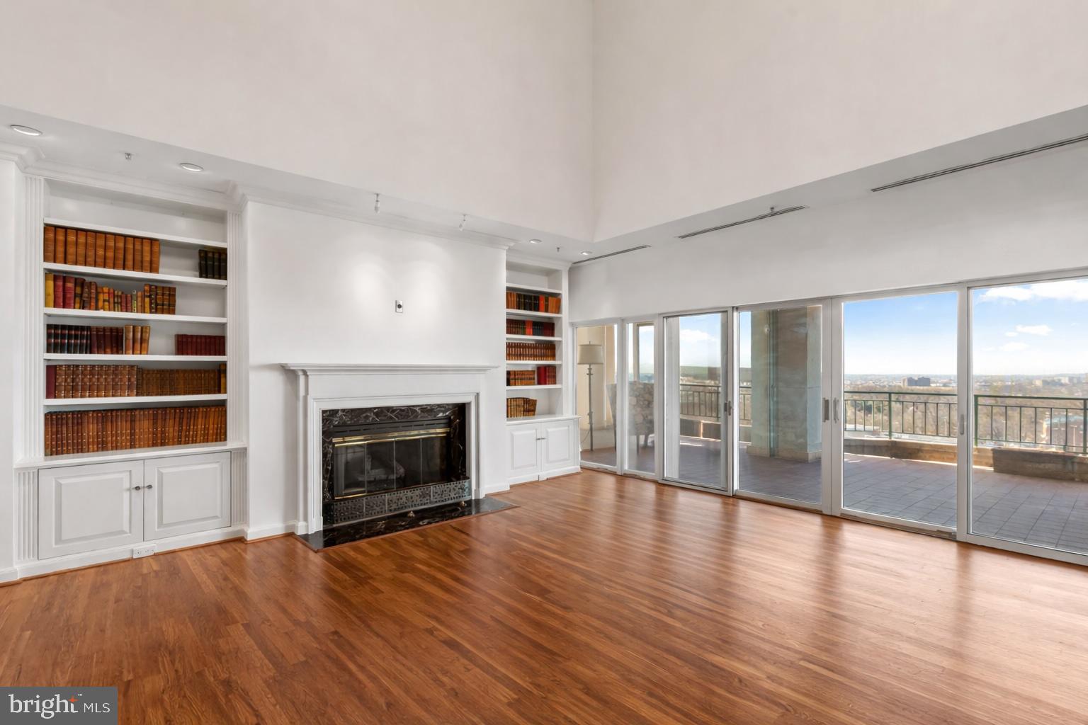 3801 Canterbury Road, Unit 1104 Baltimore, MD 21218 - Photo 5 of 74 wooden floor fireplace and windows in an empty room