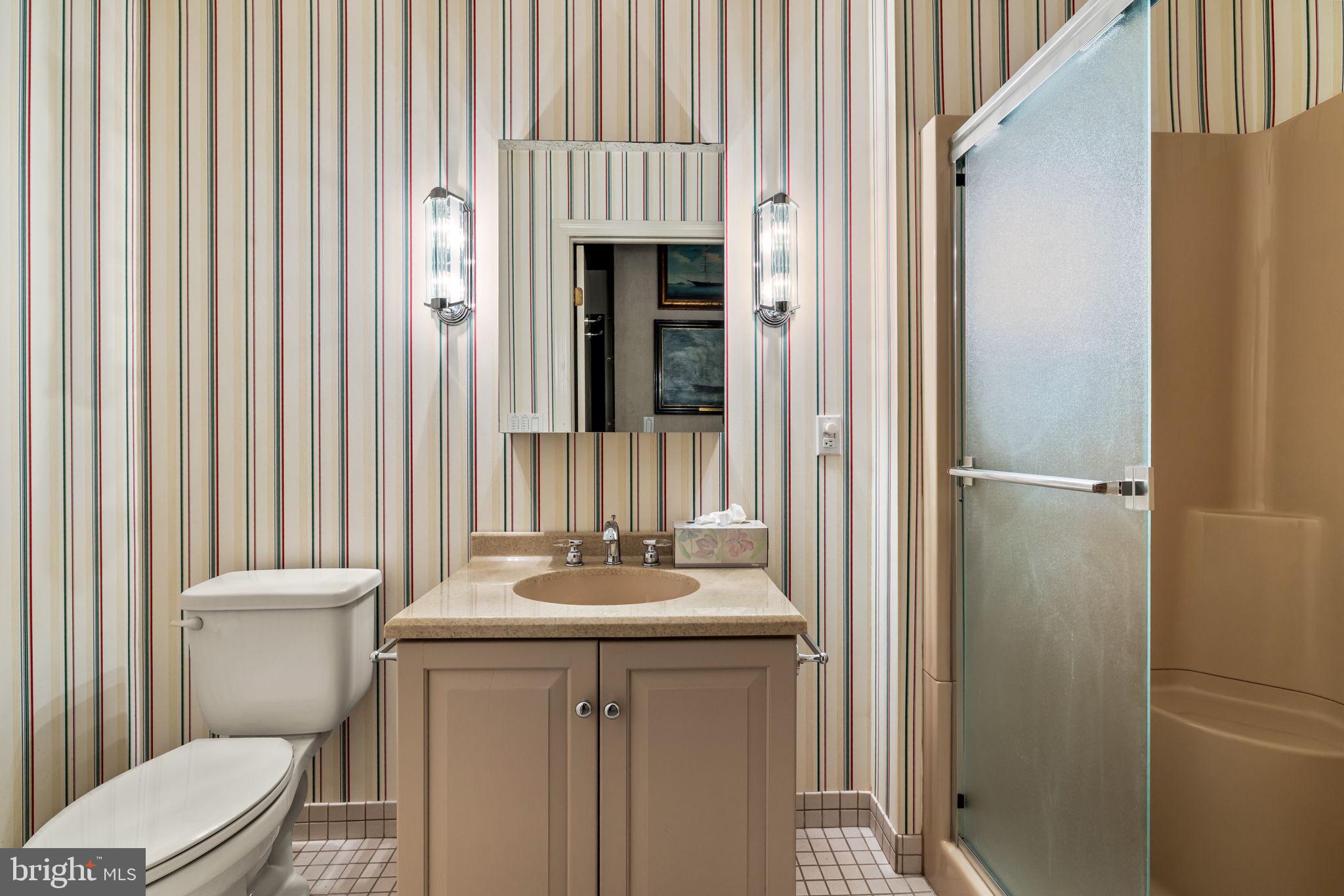 3801 Canterbury Road, Unit 1104 Baltimore, MD 21218 - Photo 59 of 74 a bathroom with a sink a toilet and shower