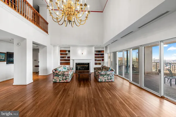 a living room with a fireplace and a book shelf