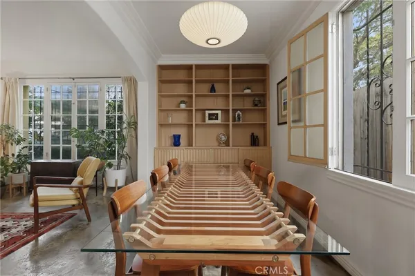 a front view of a house with wooden floor and a potted plant