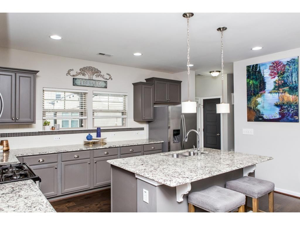 1014 Midtowne Way Durham, NC 27713 - Photo 10 of 24 a kitchen with granite countertop a sink and cabinets