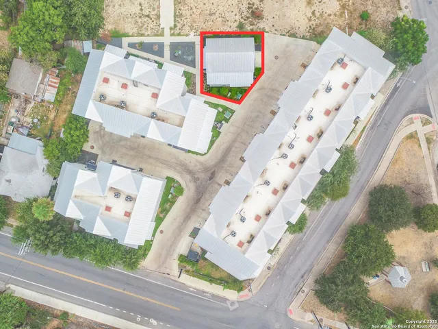 an aerial view of a house with a garden and parking