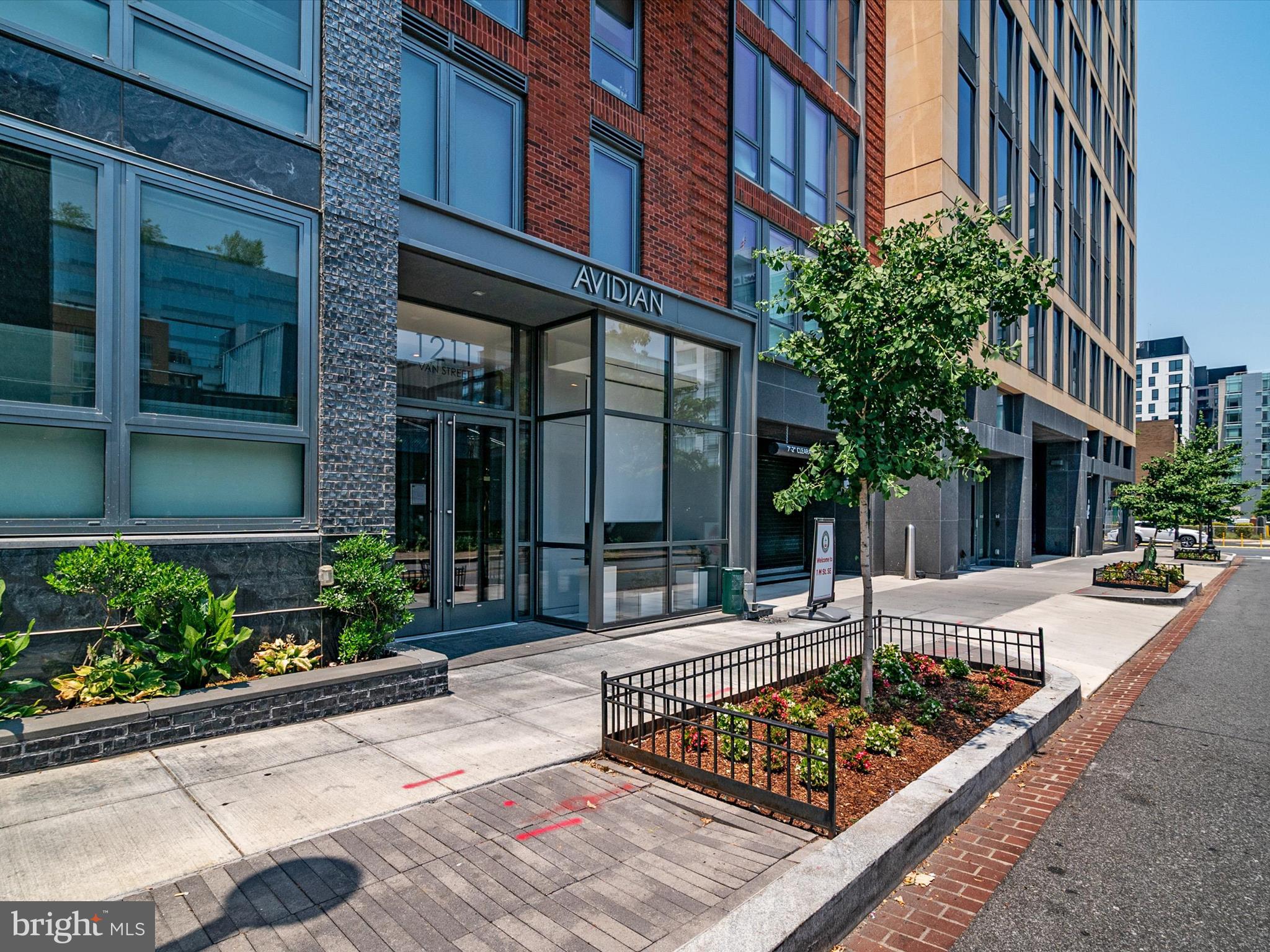1211 Van Street Southeast, Unit 1110 Washington, DC 20003 - Photo 16 of 46 front view of a building with a bench in front of building