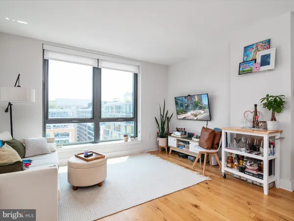 a living room with furniture and a painting on the wall