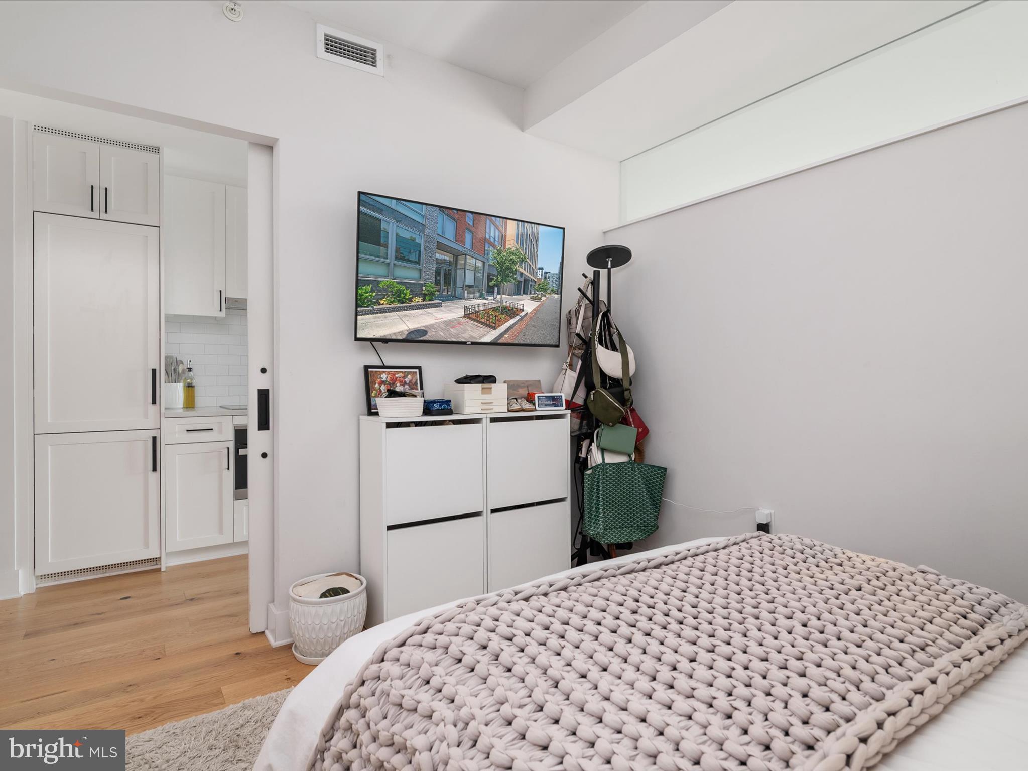 1211 Van Street Southeast, Unit 1110 Washington, DC 20003 - Photo 27 of 46 a bedroom with a bed and a flat screen tv