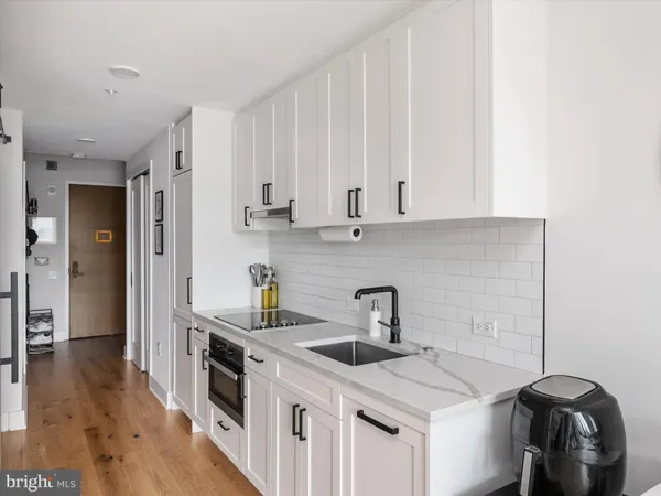 a kitchen with appliances cabinets and a sink