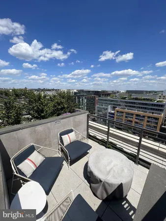 a view of a balcony with a table and chairs
