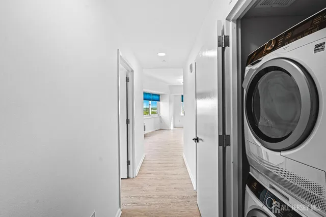 a view of a hallway with washer and dryer
